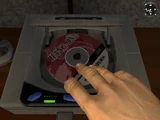 Placing the disc in the Sega Saturn.