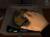 Placing the disc in the Sega Saturn.
