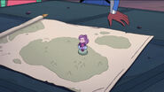 Tiny Spinnerella being placed on a map
