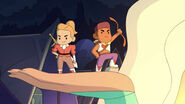 Perfuma holding up the tiny Bow and Adora figures.
