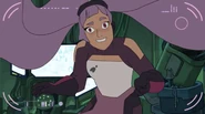 The camera zooms out; Entrapta stands on her hair in front of it