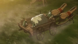 Un chariot traînant des corps