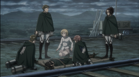 Hange's squad and Historia surround an unconscious Ymir