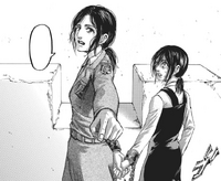 Gabi watches as Pieck points at Eren on the roof