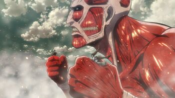 The Colossal Titan grabs Ymir and another soldier