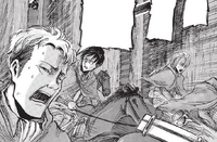 Eren looks back in horror as the Female Titan chases them