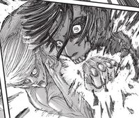 The Female Titan hardens its fist to deal a severe blow to the Attack Titan