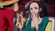 Robin feeds Luffy.