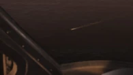 Ada watching Leon escape the island on a jet ski.