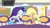 Rarity and Applejack touching each other's hands and laughing together.