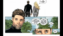 Peter and Felicia hold hands in front of Uncle Ben's grave.