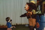 Child speaking with Billy Bob at ShowBiz Pizza in Fayetteville, Arkansas