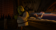 The dwarves put Snow White on Shrek's table