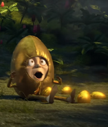 Humpty Dumpty runs into a heavy golden egg, hitting himself in the crotch.