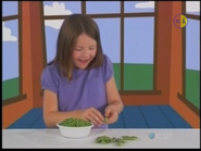 Leah putting peas