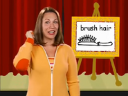 Brush hair. Just like you’re holding a brush and brushing your hair. Brush hair.