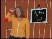 Donkey! Put your thumb on the side of your forehead and wave your whole hand like a donkey’s ear. Donkey!