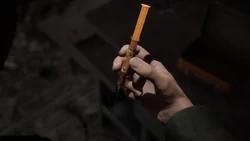 James holding a syringe.