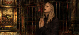 Claudia praying to God after murdering Vincent.