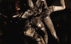 Pyramid Head attacks two Mannequins.