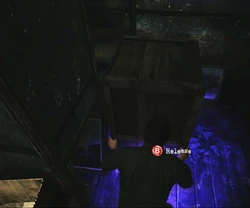 Pushing a crate out of the way to find a the "Hope" painting.