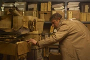Chris searches the archives for evidence of Silent Hill's past.