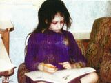 Jodelle Ferland doing homework between shots in full Dark Alessa garb.[1]