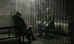 James talking to Maria behind bars.