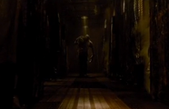 Leonard's monster form on a dark corridor.