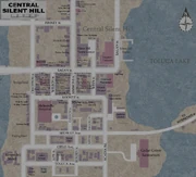Un mapa de Central Silent Hill. Industry Dr es la tercera en vertical con forma curvada desde el oeste, en el sur del distrito.