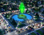 A square, paved park with a floating, large green plumbob above a circular fountain in the center.