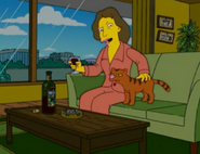 Young Eleanor (32) showing symptoms of psychological exhaustion and alcoholism, with her first cat, Buster.