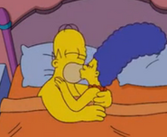 Marge naked with Homer in bed.