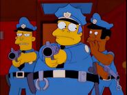 Wiggum aims his gun