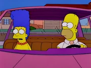 Marge's hair in front of the car's windshield.