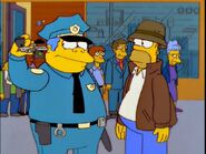 Wiggum scratches his ear using his gun