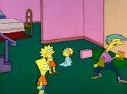 Ms. Botz walks into the living room to put on "The Happy Little Elves" for the children.