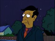 Skinner stands in the dark