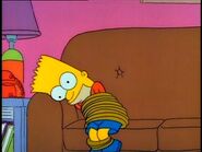 Bart has had it with The Happy Little Elves, so he pounds his head on the armrest.