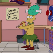 Sideshow Mel is blowing the slide whistle.