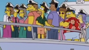 Sarah and others on a boat wearing captains caps