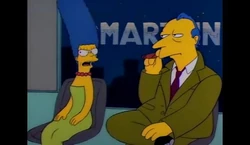 Marge with Roger Meyers on Smartline discussing Itchy and Scratchy.