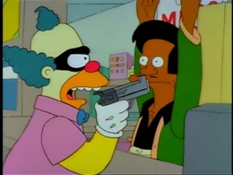 "Krusty the Clown" threatening Apu at gunpoint.
