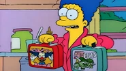Marge tries to give the children their lunchboxes...