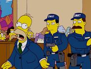 Homer being hit and knocked out by a S.W.A.T. member