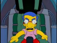 Milhouse playing with an air fighter's cockpit