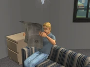 A Sim reading the newspaper in The Sims 2.