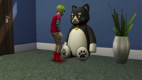 A child playing with a big puds teddy bear in The Sims 4.