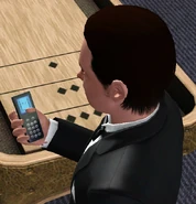A Sim using his mobile phone in The Sims 3