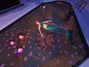 A mermaid sleeping on a swimming pool.